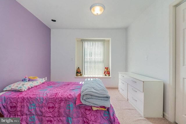 bedroom featuring light colored carpet