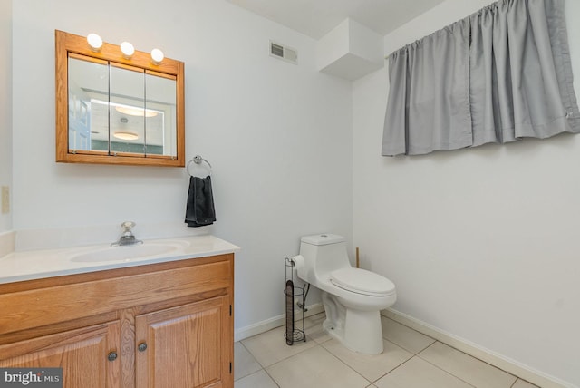 bathroom with visible vents, vanity, tile patterned flooring, and toilet