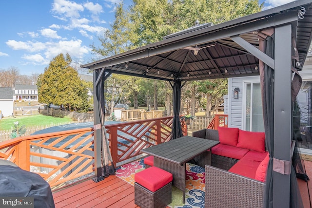 deck featuring fence and a gazebo