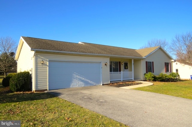 ranch-style home with a porch, a garage, driveway, and a front yard