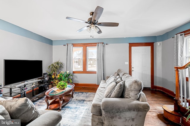 living room featuring ceiling fan, wood finished floors, and baseboards