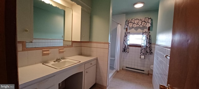 full bathroom featuring a baseboard radiator, toilet, vanity, and curtained shower