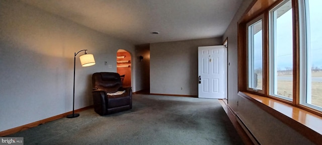 unfurnished room featuring carpet, arched walkways, and baseboards