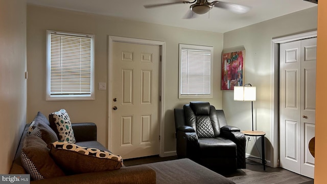 sitting room with ceiling fan and wood finished floors