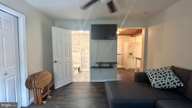 living area featuring ceiling fan, wood finished floors, and baseboards