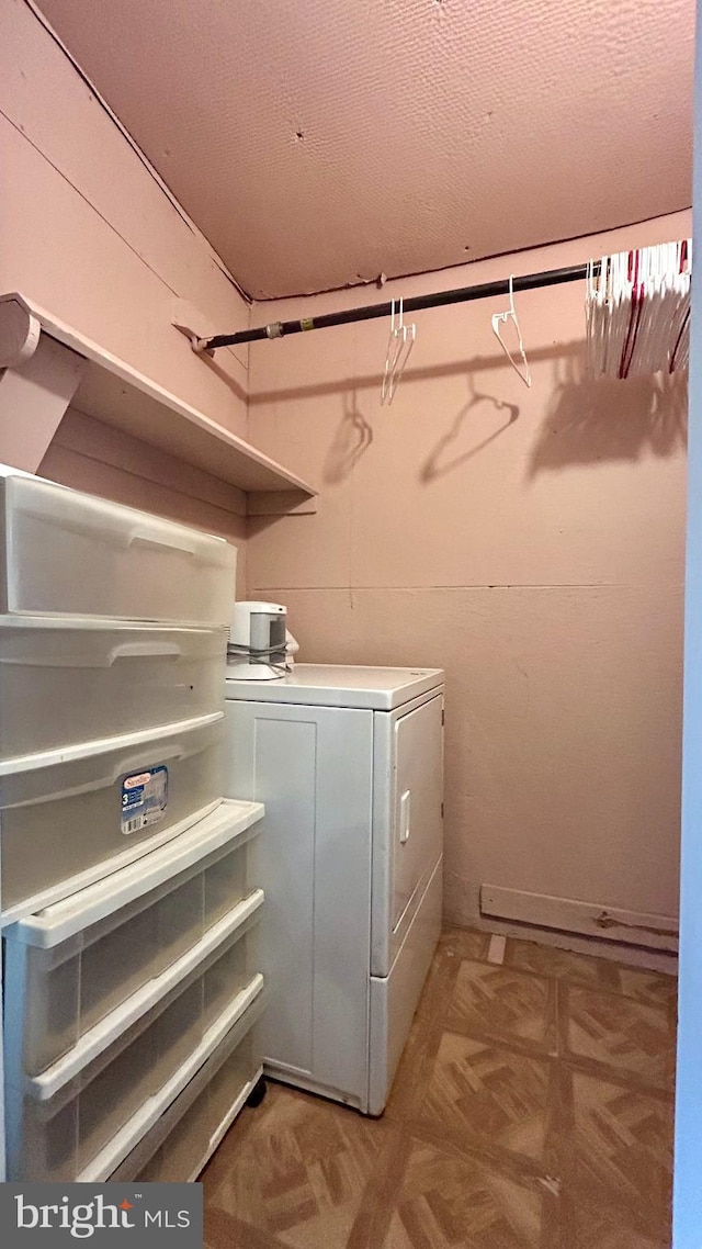 laundry room with laundry area and washer / dryer