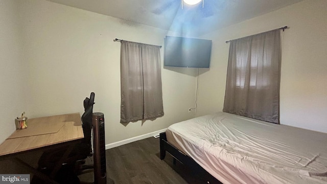 bedroom with wood finished floors and baseboards