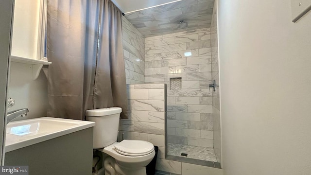 full bathroom with vanity, walk in shower, and toilet