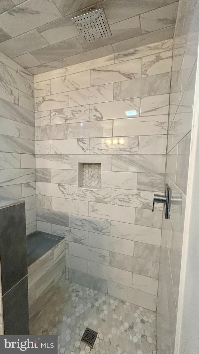 bathroom with tiled shower