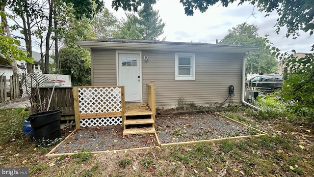 back of property with a wooden deck and central air condition unit