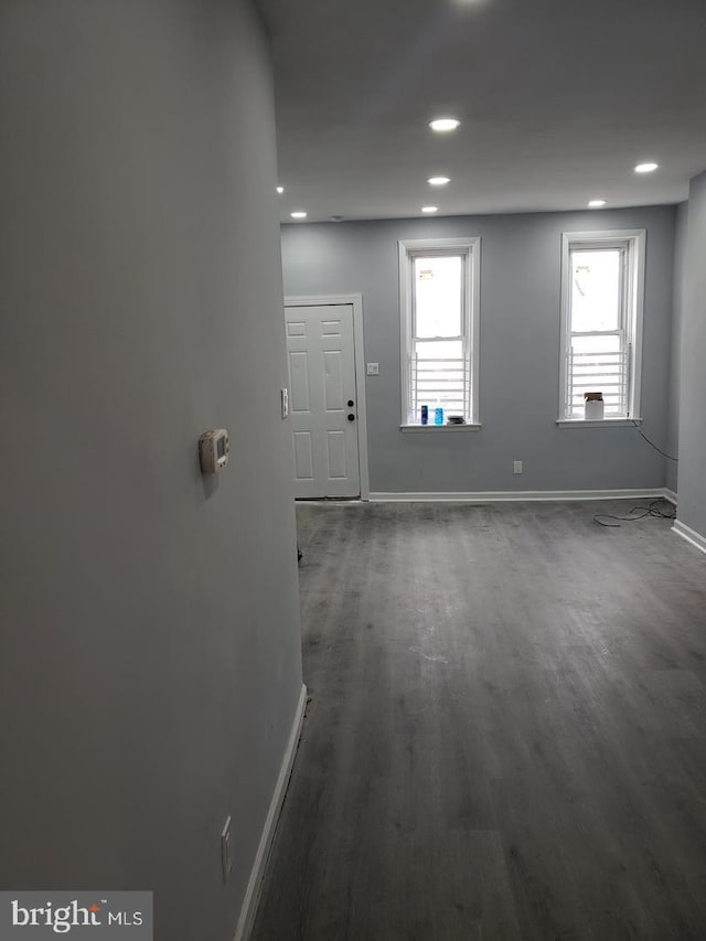 unfurnished room featuring dark wood-style floors, baseboards, and recessed lighting