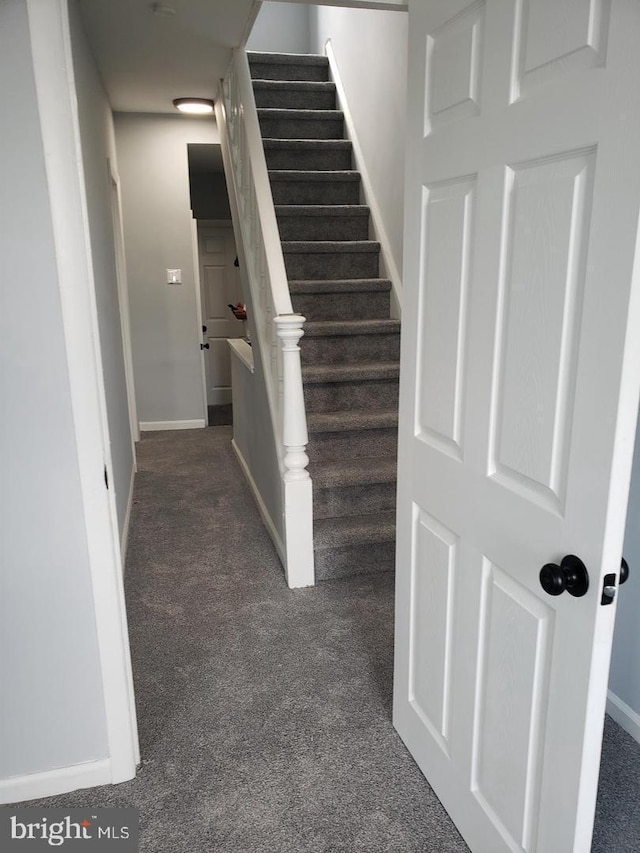 staircase with carpet and baseboards