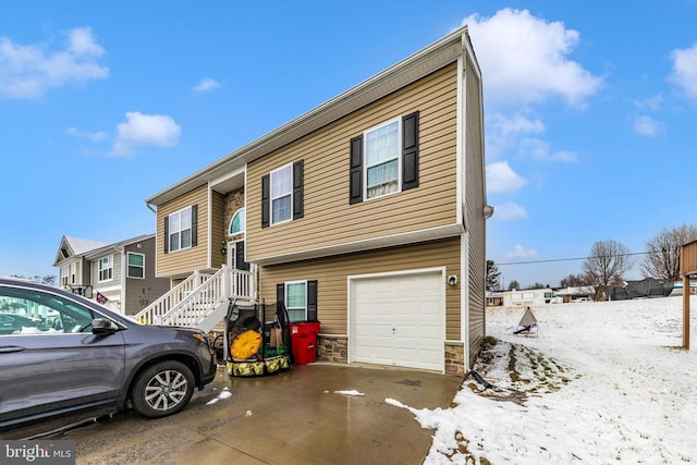 view of front of property featuring stone siding and an attached garage