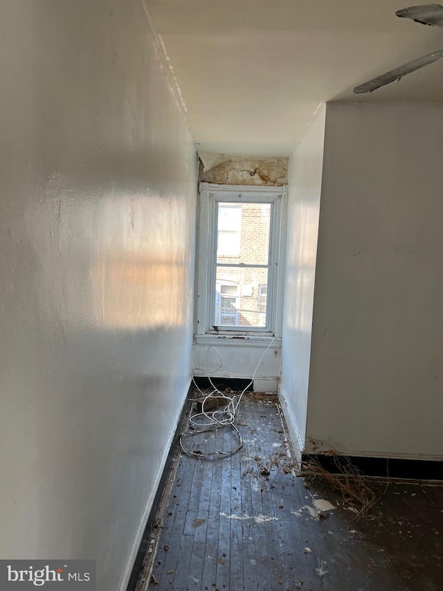 interior space with baseboards and wood-type flooring