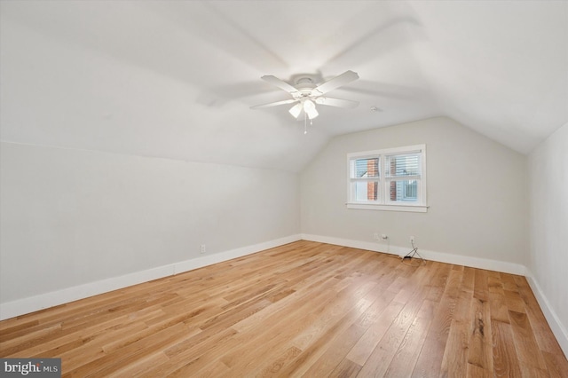 bonus room with lofted ceiling, ceiling fan, wood finished floors, and baseboards