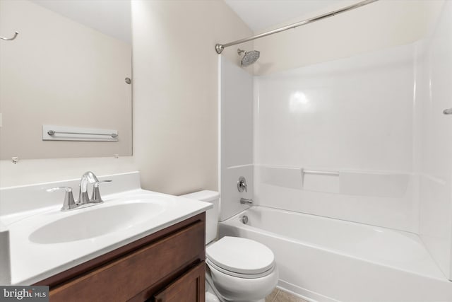 bathroom with washtub / shower combination, vanity, and toilet