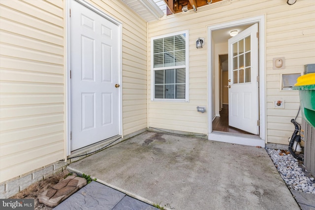 view of exterior entry with a patio