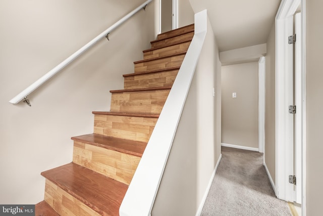 stairway featuring carpet and baseboards