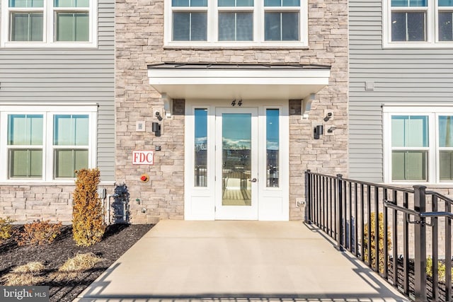 doorway to property featuring stone siding