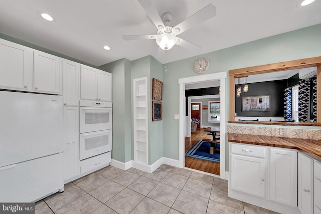 kitchen with light tile patterned floors, ceiling fan, recessed lighting, white appliances, and white cabinets