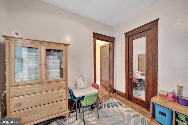 interior space featuring light wood-style floors and baseboards