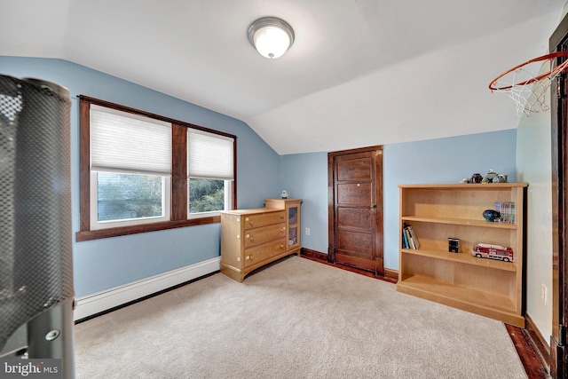 carpeted bedroom featuring vaulted ceiling, a baseboard radiator, and baseboards