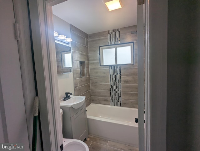 full bathroom featuring washtub / shower combination, vanity, and tile patterned floors