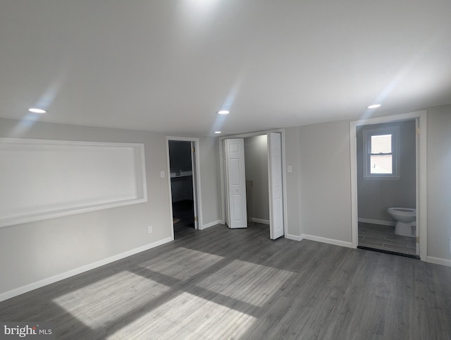 interior space with dark wood-type flooring, recessed lighting, and baseboards