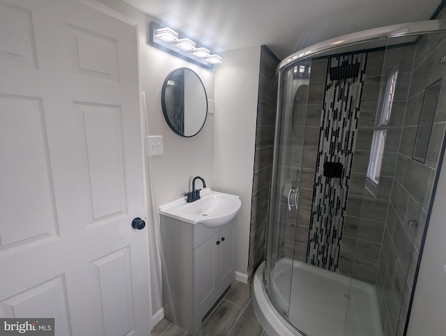 bathroom featuring a shower stall and vanity