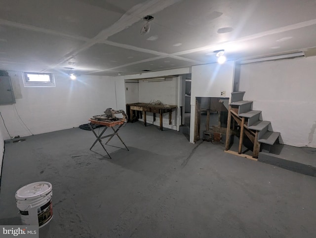 basement with electric panel and stairs