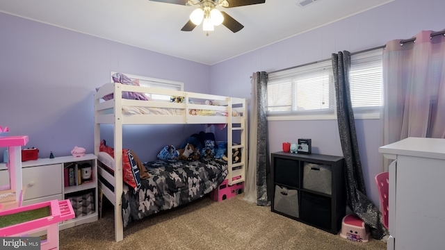 carpeted bedroom featuring visible vents and a ceiling fan