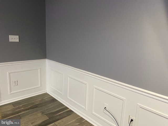 details with a wainscoted wall and wood finished floors