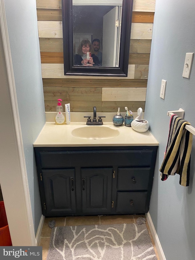 bathroom with wood walls and vanity