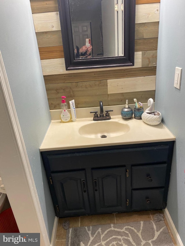 bathroom featuring wood walls and vanity