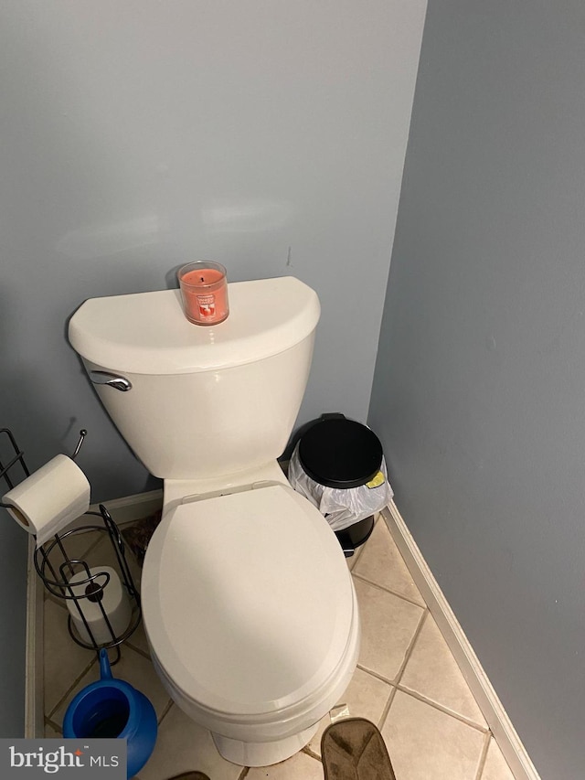 bathroom with baseboards and tile patterned floors