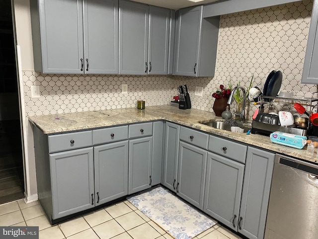 kitchen with gray cabinets, dishwasher, and a sink