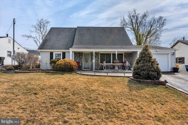 view of front of home with driveway, a front lawn, stone siding, covered porch, and an attached garage