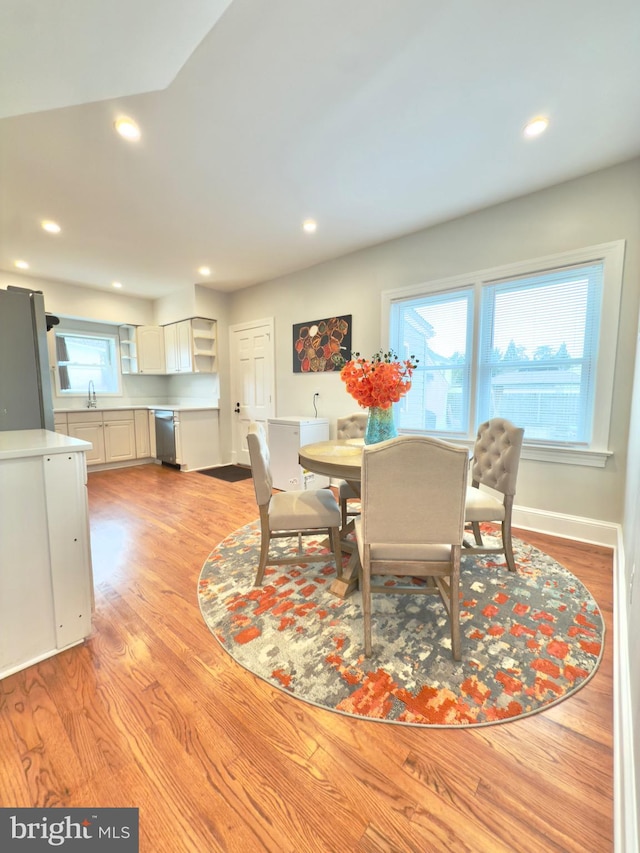 dining room featuring recessed lighting, light wood-type flooring, and baseboards