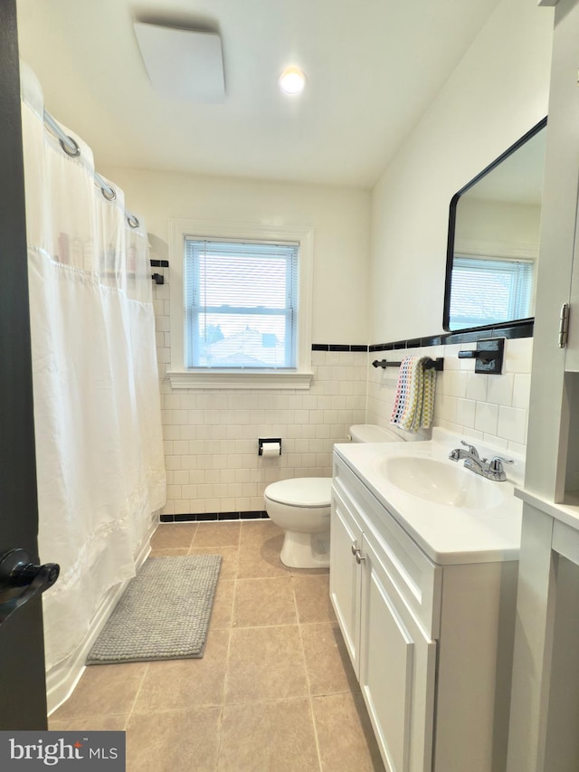 full bath featuring toilet, tile walls, and vanity