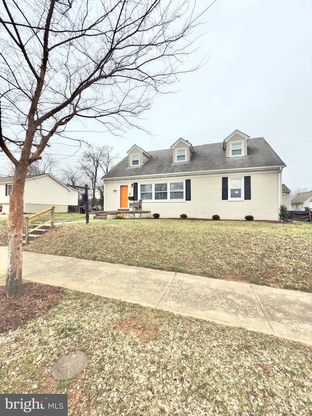 cape cod-style house with a front yard