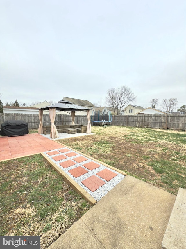 view of yard with a gazebo, a patio, a trampoline, and a fenced backyard