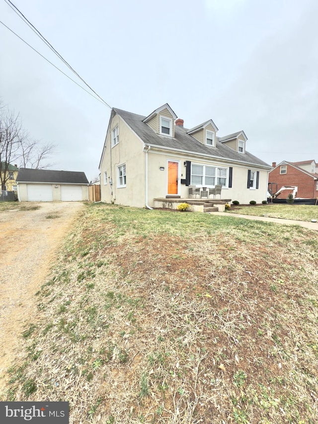 view of front of home featuring stucco siding and an outbuilding