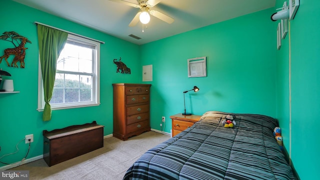 bedroom with a ceiling fan, light carpet, visible vents, and baseboards