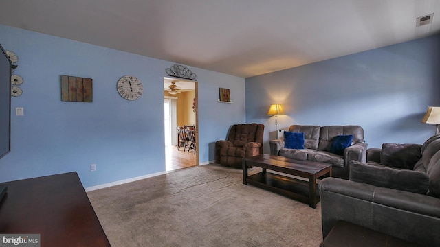 living room with baseboards, visible vents, and carpet flooring