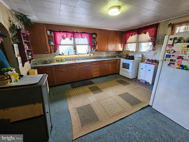 kitchen featuring light countertops, white appliances, open shelves, and a healthy amount of sunlight