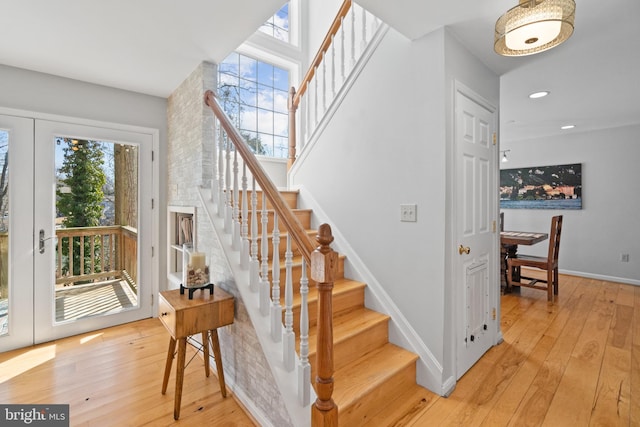 stairway featuring recessed lighting, french doors, baseboards, and wood finished floors