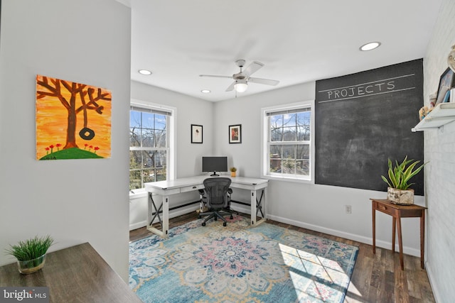 home office featuring plenty of natural light, dark wood finished floors, and baseboards