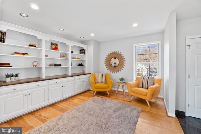 sitting room with light wood-style floors, baseboards, and recessed lighting