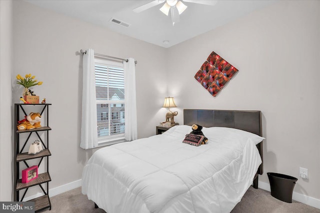 carpeted bedroom featuring visible vents and baseboards