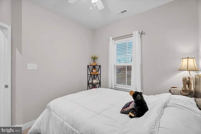 bedroom featuring a ceiling fan, visible vents, and baseboards